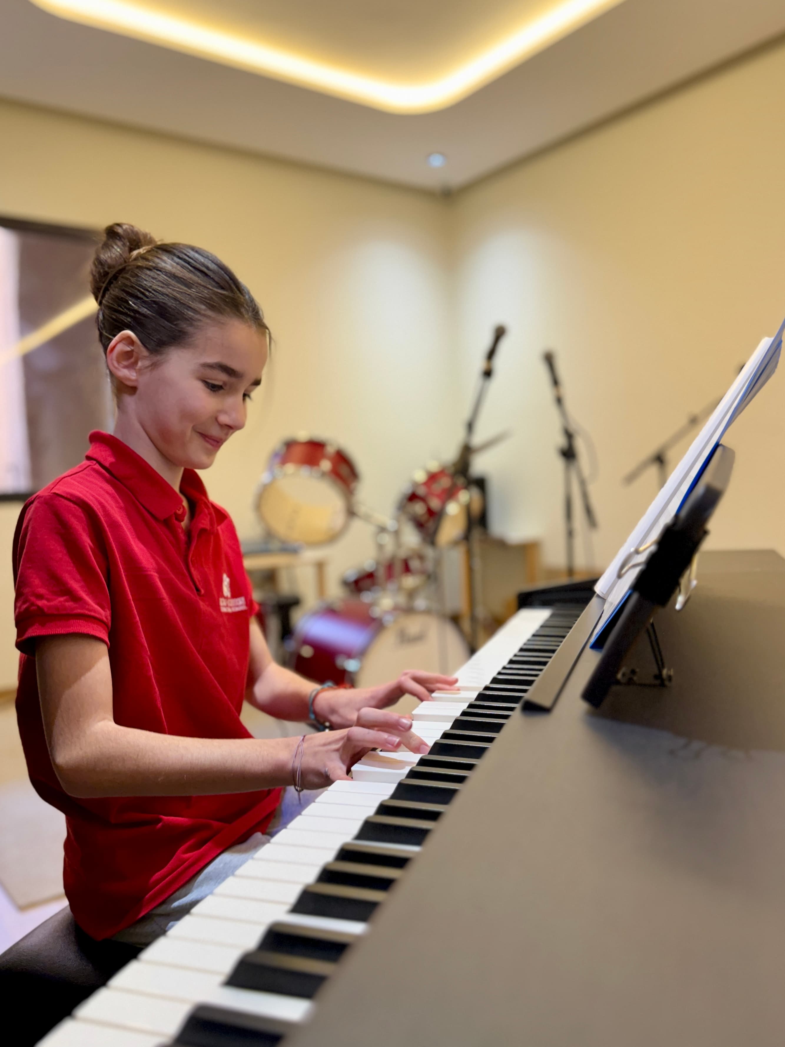 A student practising piano in the school music room
