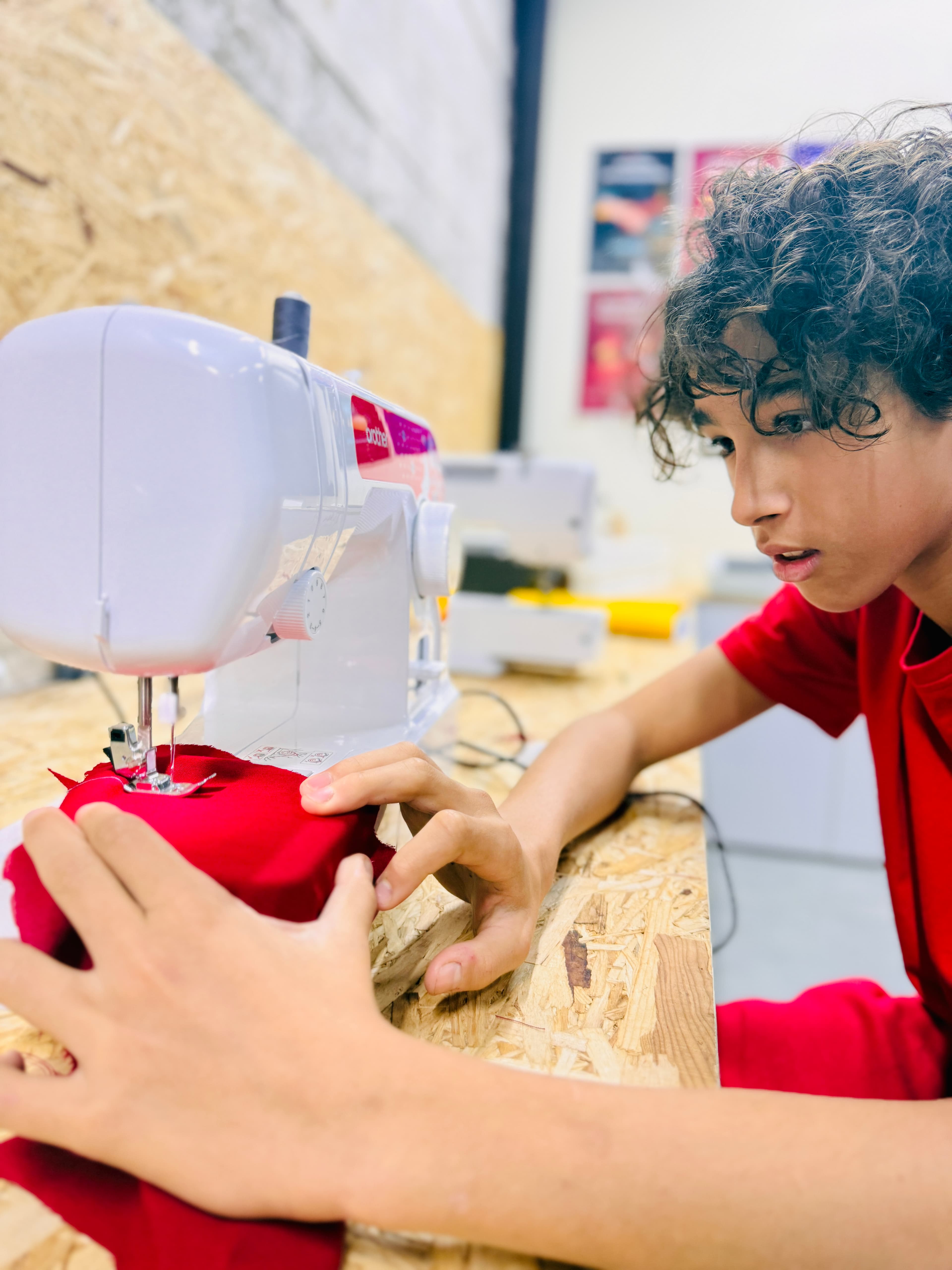 A student concentrating on a creative sewing project