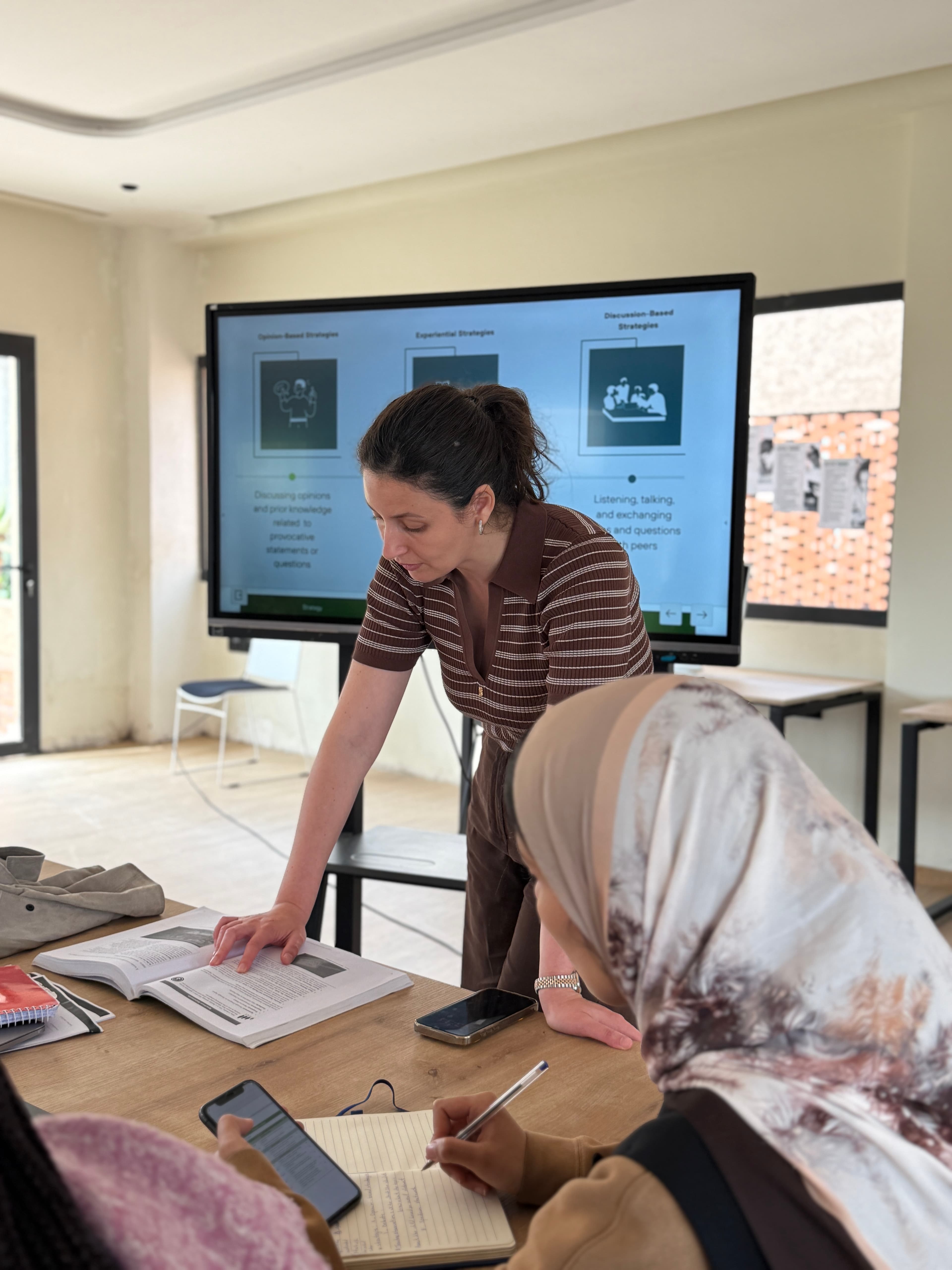 A teacher guiding students through a collaborative lesson
