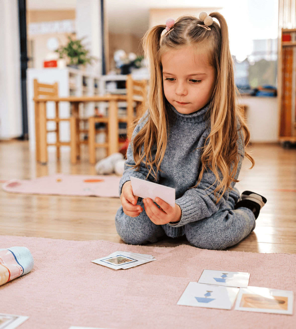 A Children’s House learner working with Montessori materials
