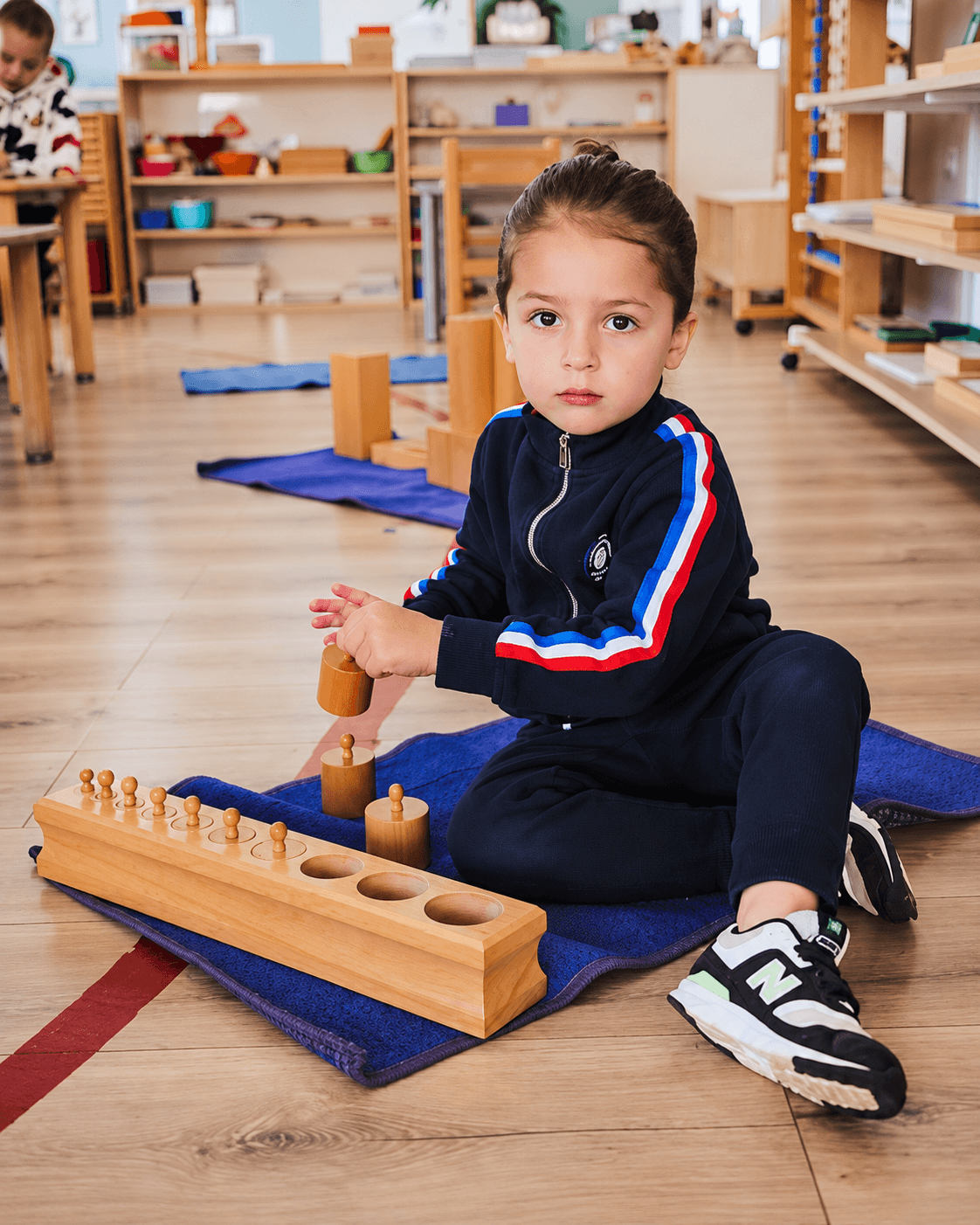 A young learner concentrating on a hands-on activity