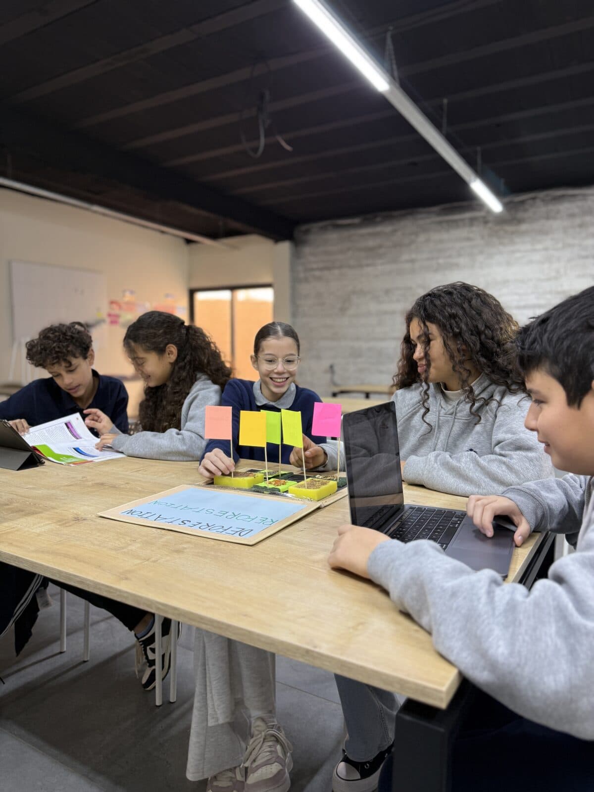 Secondary students collaborating around a table