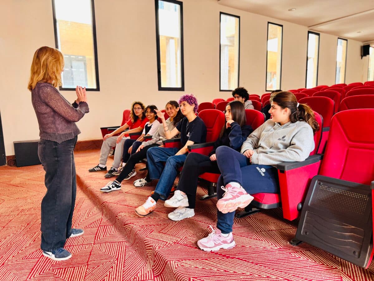 Students listening to a speaker in the amphitheatre
