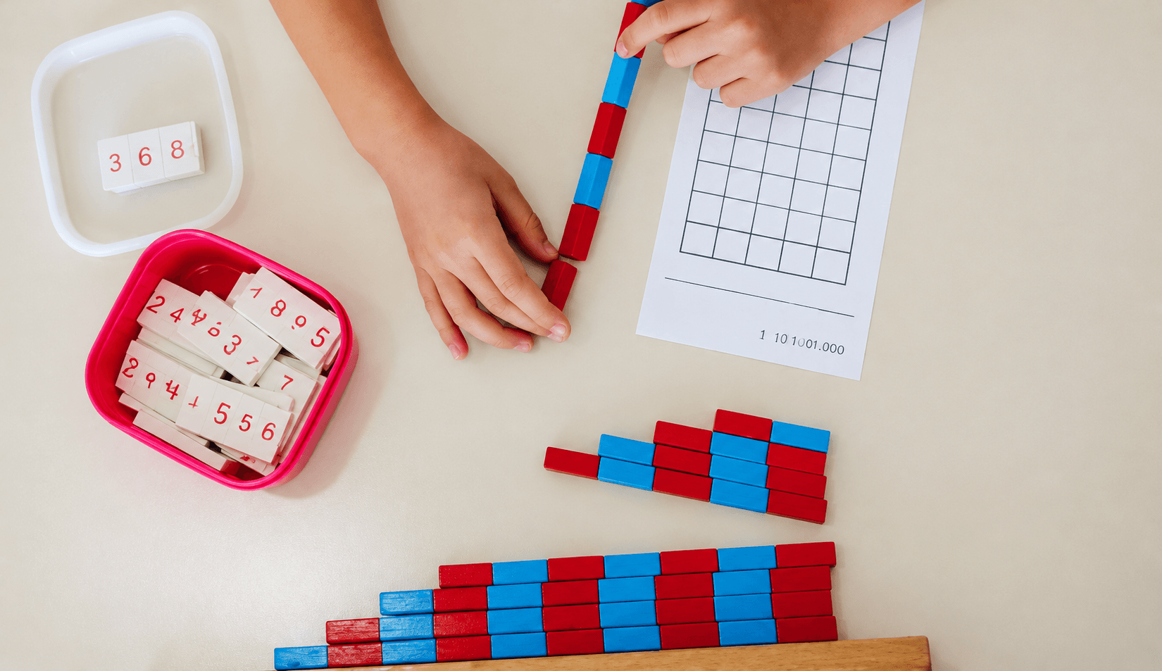 A child counting with Montessori bead bars