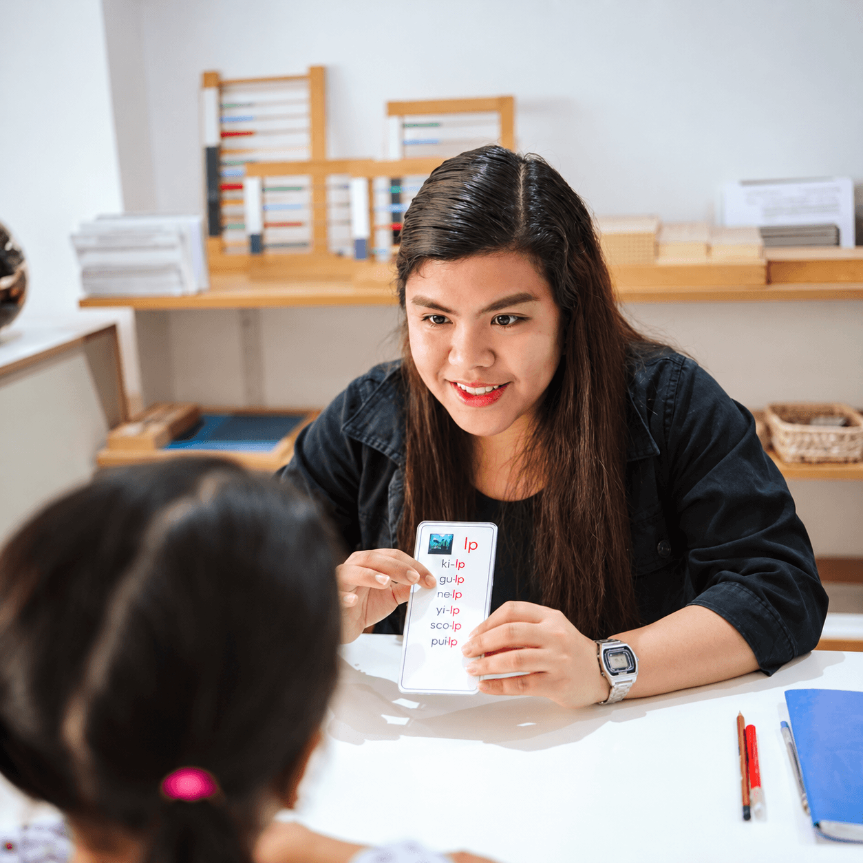 An ESL teacher working with a learner using reading cards